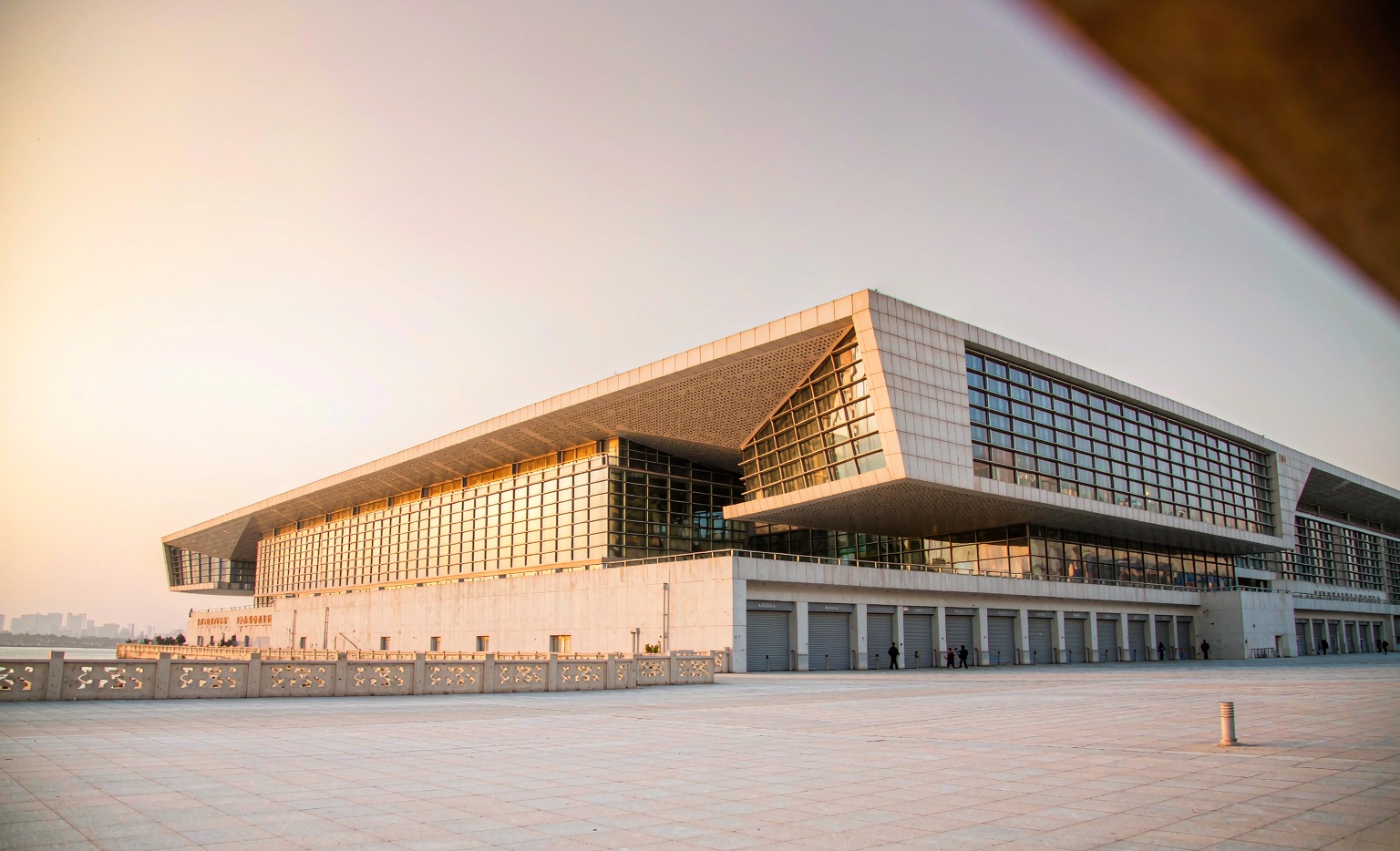 Canton Fair 2026 Pazhou complex exterior at golden hour, riverfront exhibition center in Guangzhou