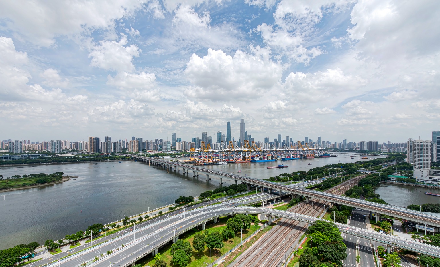 Guangzhou cityscape with Pearl River, metro viaduct and shipping port cranes supporting Canton Fair logistics