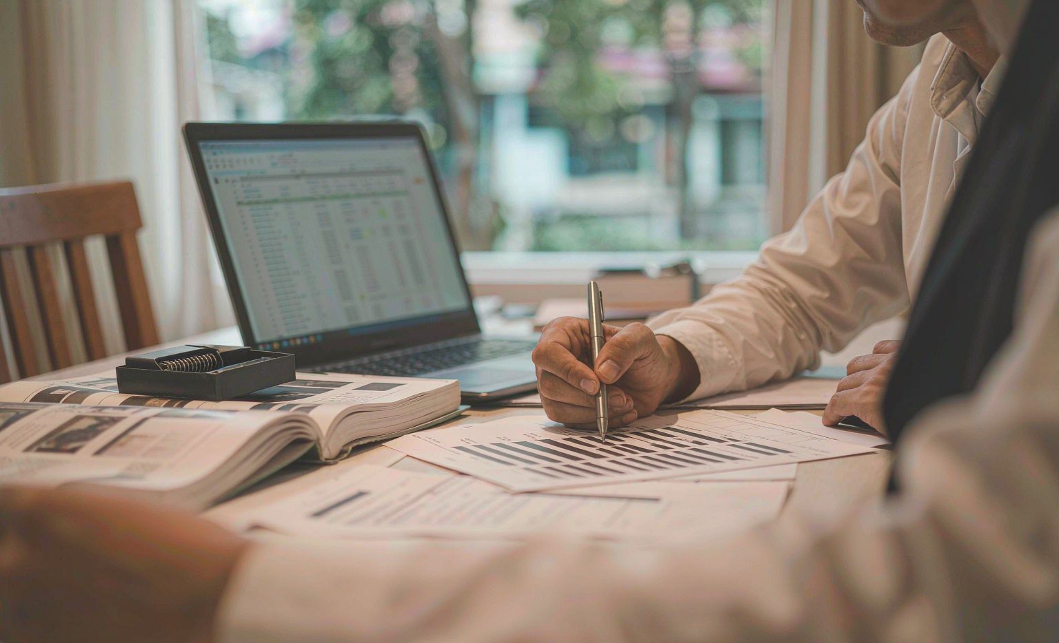 Buyer cross-checking a Hyundai and Kia part number list against a printed catalogue and a laptop database