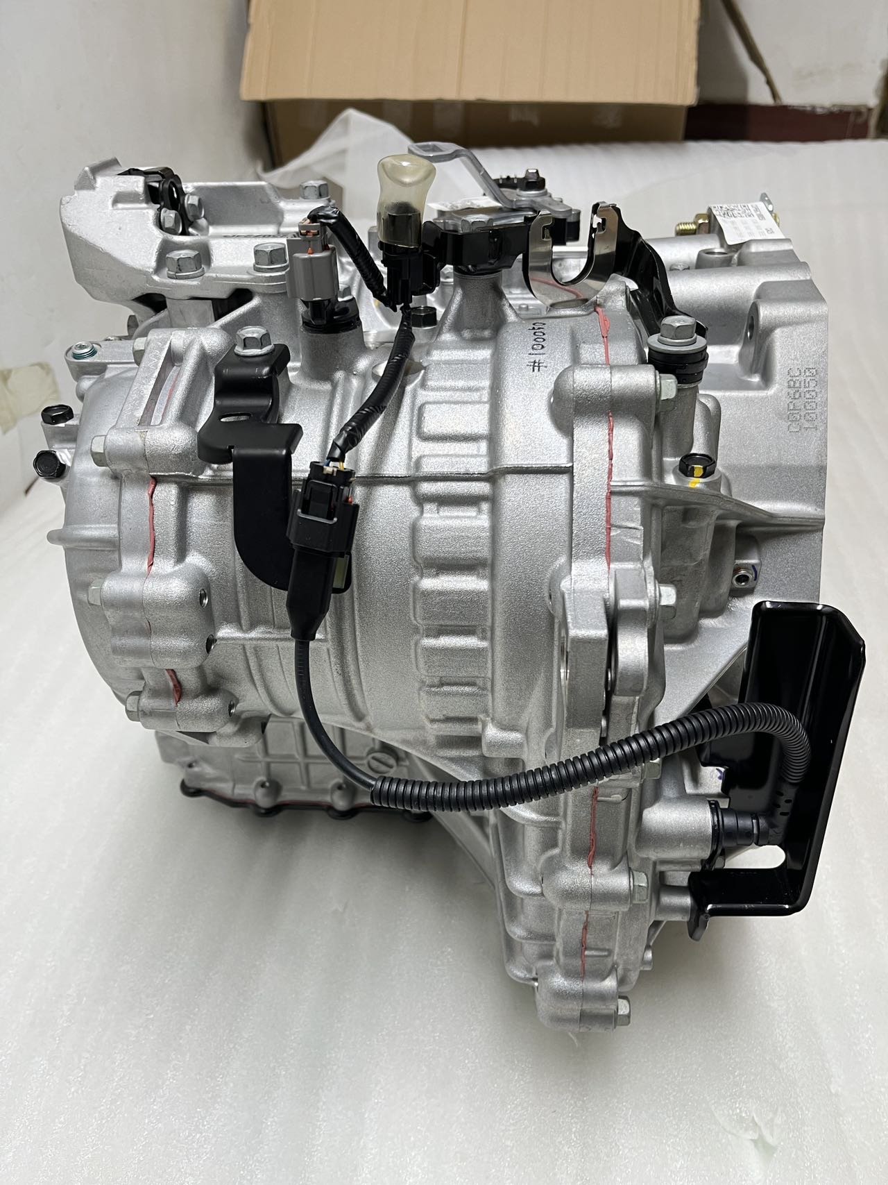 Hyundai Kia automatic transmission rear view — showing electronic control module connector, output speed sensor, wiring harness and ATF cooler line fittings for A6MF1 gearbox