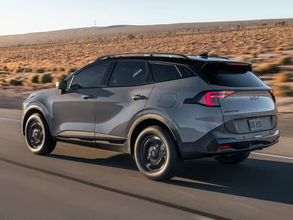 2026 Kia Sportage gray rear three-quarter view — dynamic driving shot showing roof rails and LED tail lights, compact SUV export from China
