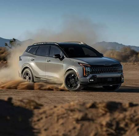 2026 Kia Sportage silver kicking up dust on dirt road — dynamic off-road performance, AWD terrain modes, compact SUV export from China via Globalucar