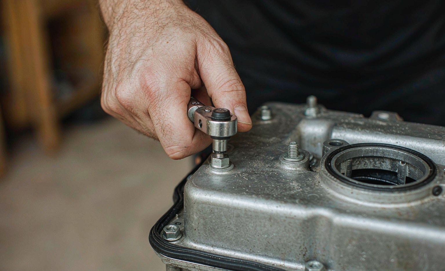 Torque wrench set to a low value being used on M6 valve cover bolts in a cross pattern on an aluminium cylinder head