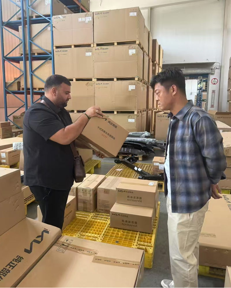 Client inspecting auto parts quality on-site